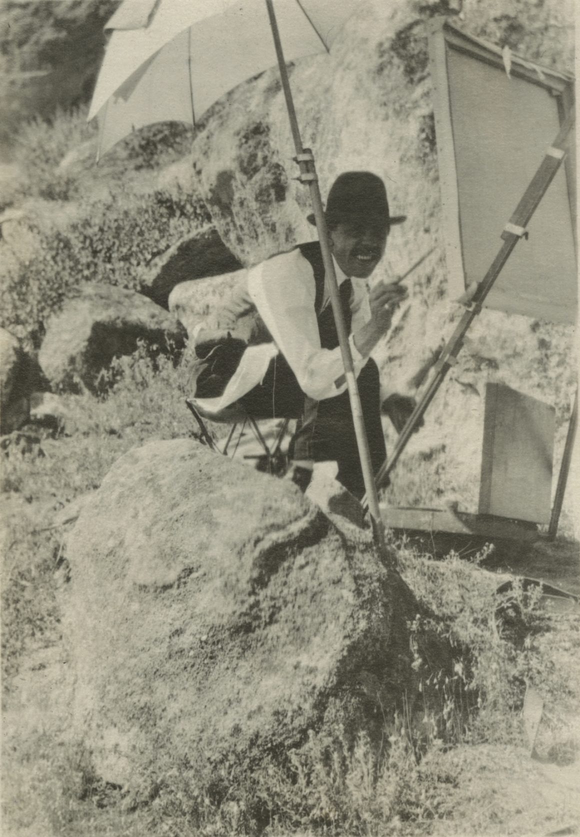 A black and white photograph of Raymond Jonson painting in Boulder Colorado, 1917