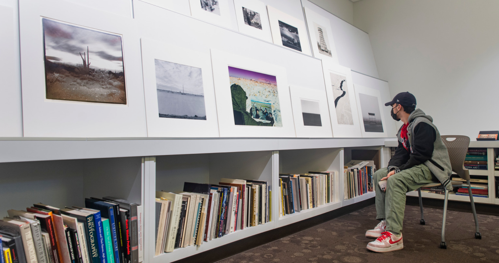 Photo of a student looking at a selection of prints in the Beaumont Newhall Study Room.